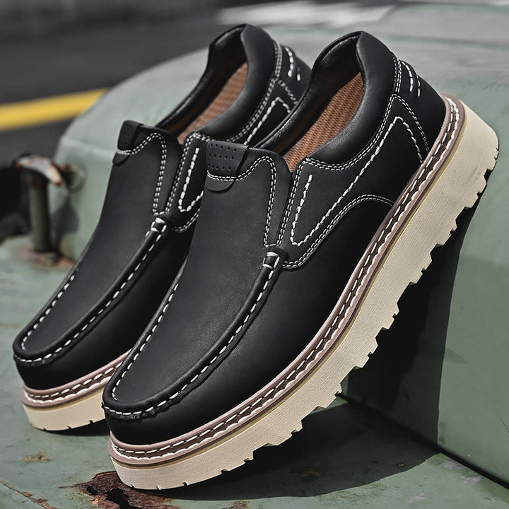 Brown and black moc-toe loafers with contrast stitching and lug soles