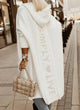 Woman wearing a longline hooded knit cardigan with graphic back lettering