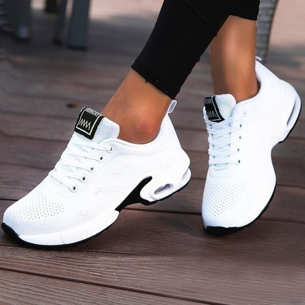 Women's low-top lace-up sneakers with perforated panels and air cushion-style soles