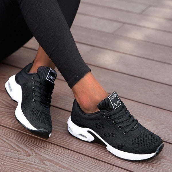 Women's low-top lace-up sneakers with perforated panels and air cushion-style soles