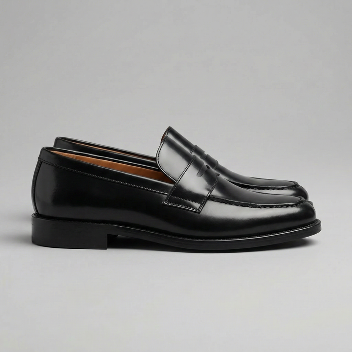 Men's black penny loafers with glossy finish, almond toe and low heel