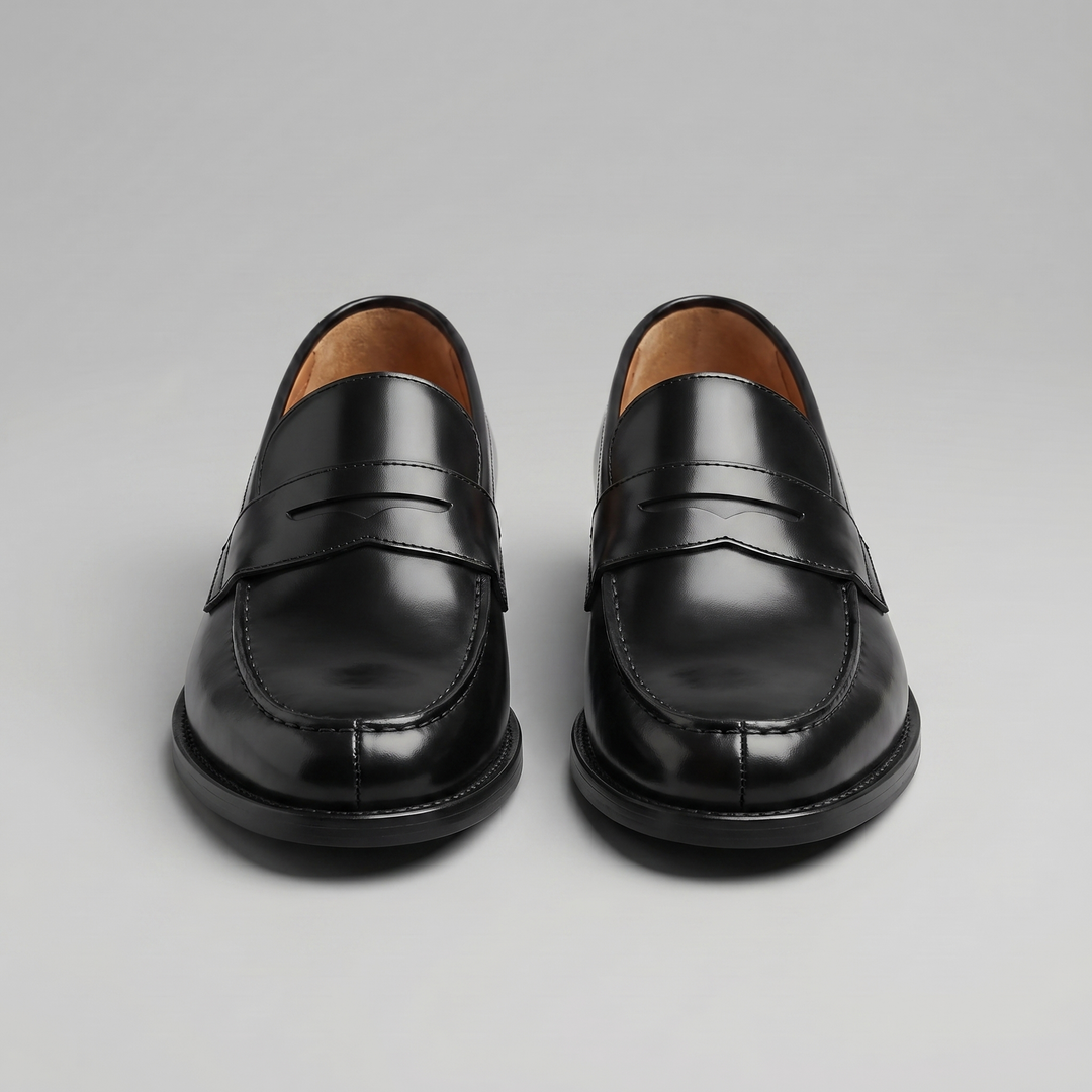 Men's black penny loafers with glossy finish, almond toe and low heel