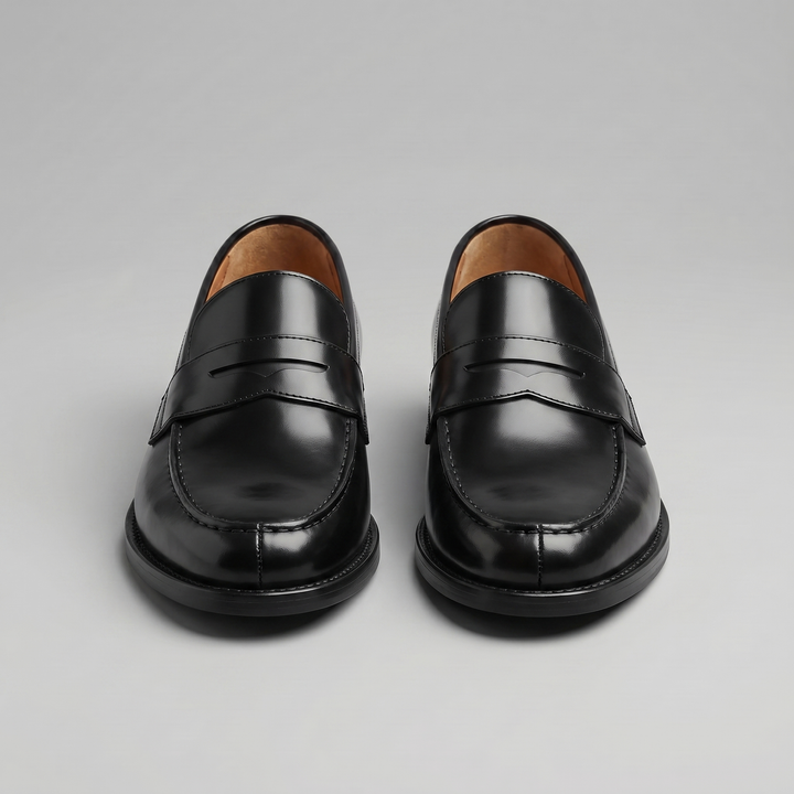 Men's black penny loafers with glossy finish, almond toe and low heel
