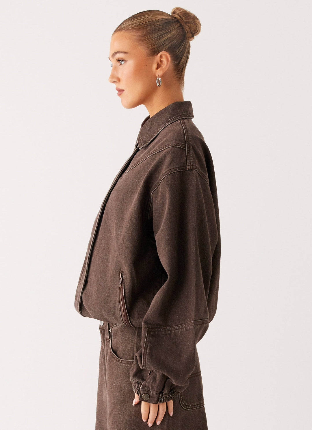 Women's brown washed denim bomber jacket with cropped fit and long sleeves
