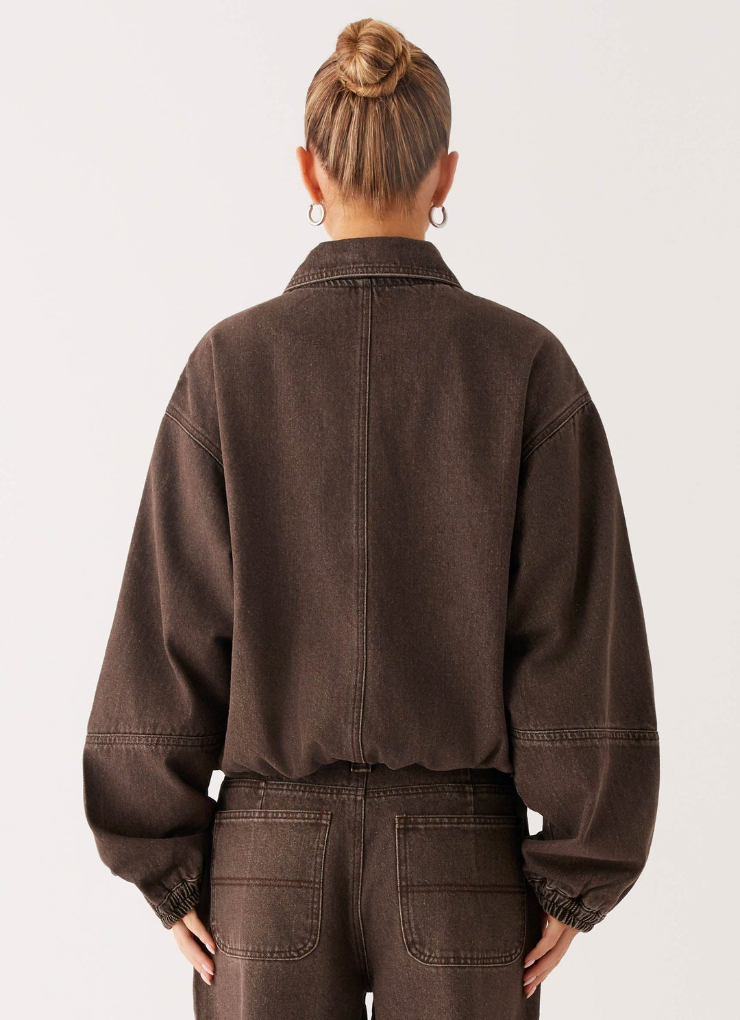 Women's brown washed denim bomber jacket with cropped fit and long sleeves