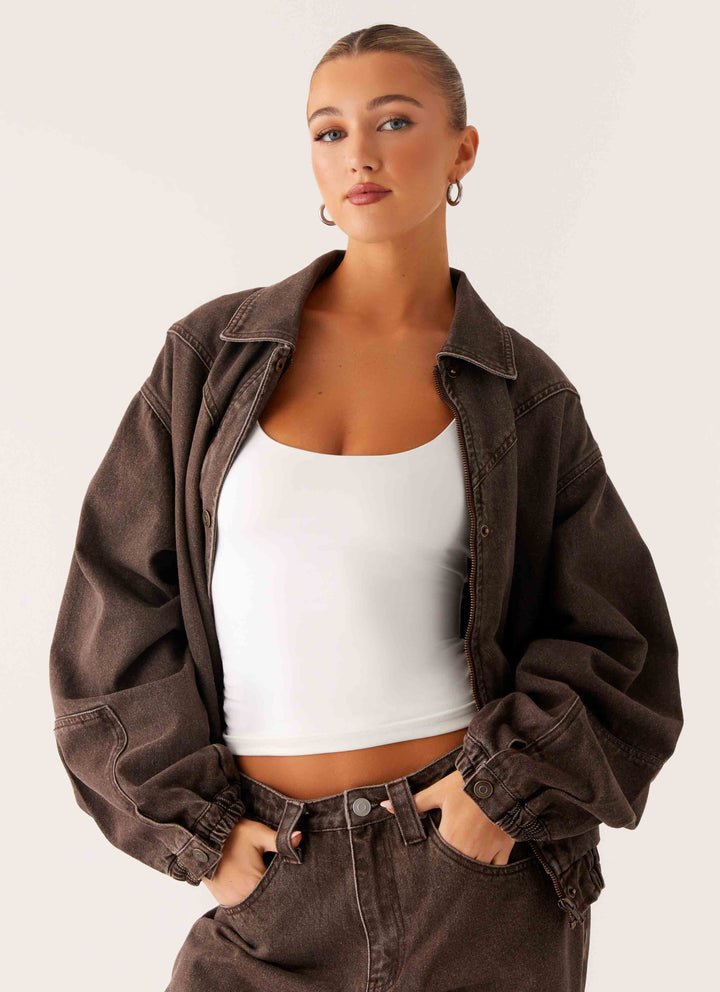 Women's brown washed denim bomber jacket with cropped fit and long sleeves