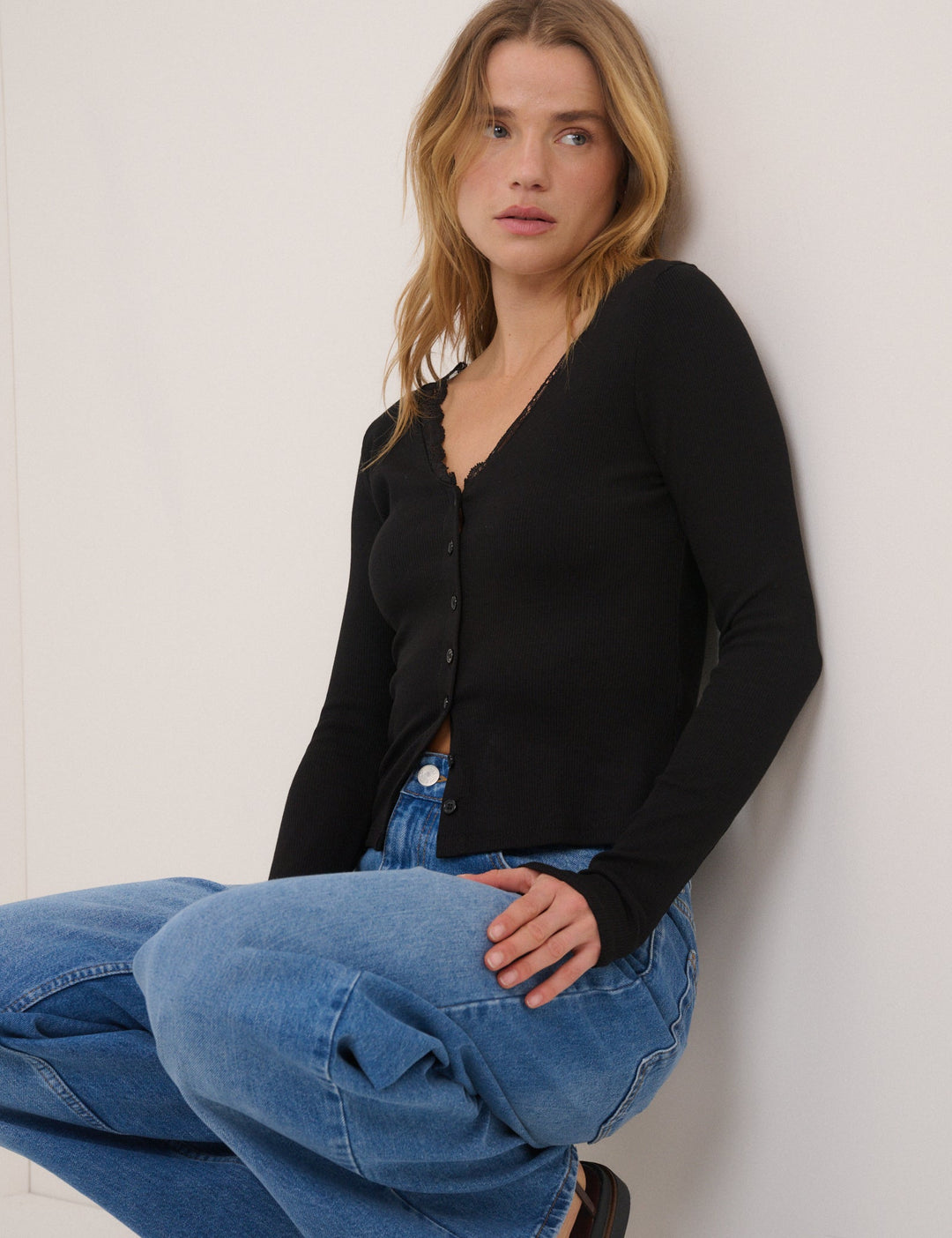 Women's black ribbed cardigan with lace-trim V-neckline and long sleeves