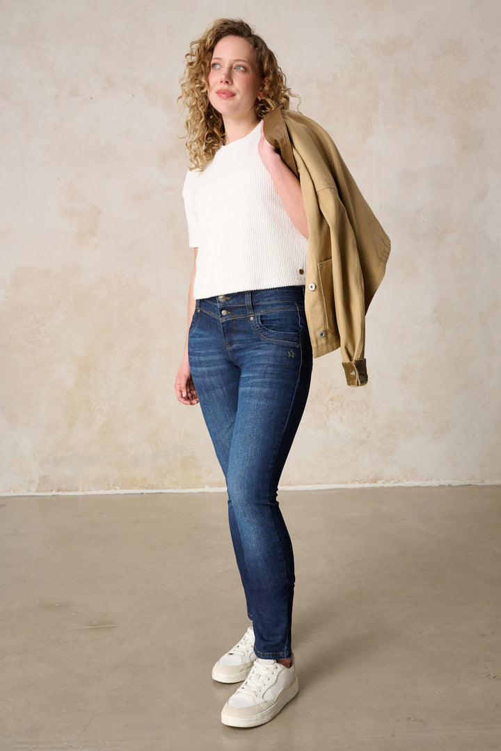 Women's dark blue slim fit jeans with mid-rise button fly and five pockets