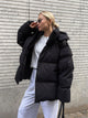 Women's oversized hooded puffer jacket with zip front