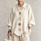 Women's oversized textured collared cardigan with large buttons and curved hem