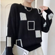 Women's patchwork crew-neck sweater with contrasting geometric panels