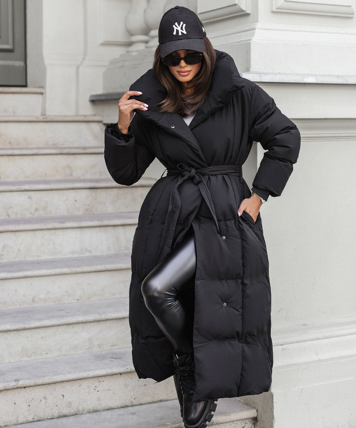 Women's black long belted puffer coat with raised collar