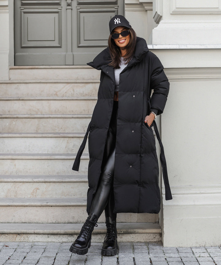 Women's black long belted puffer coat with raised collar