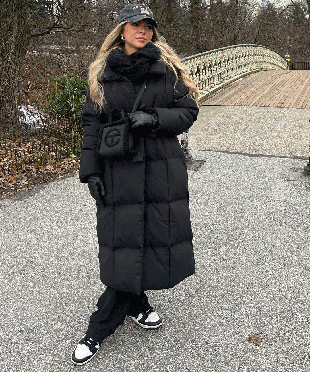 Women's black long belted puffer coat with raised collar