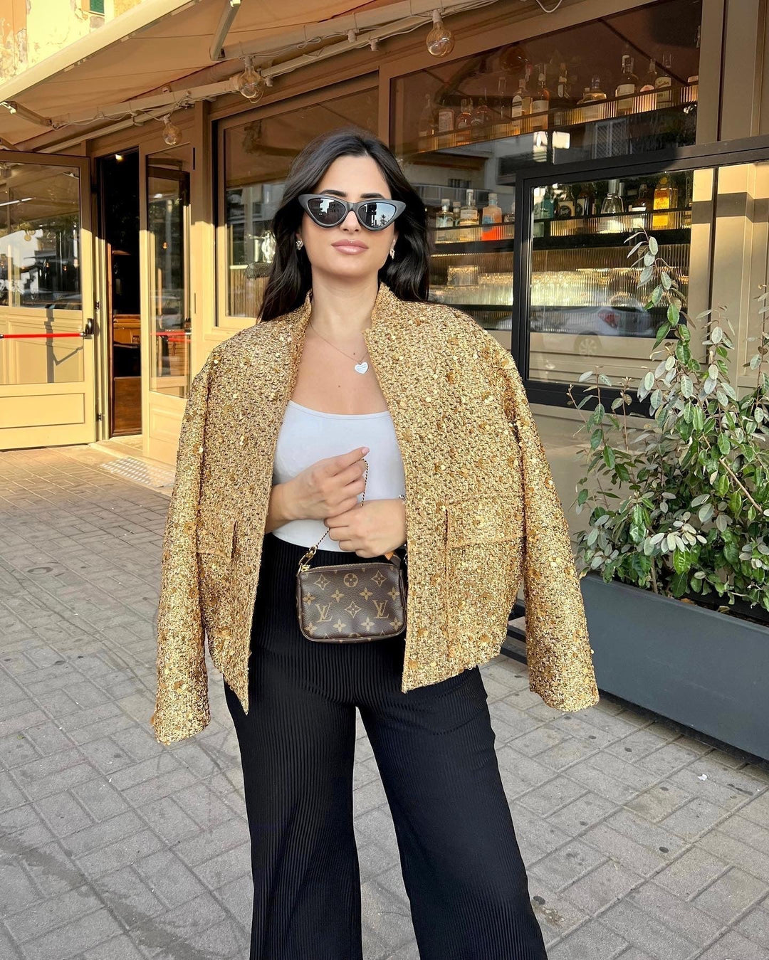 Women's textured metallic jacket with stand collar, long sleeves and front pockets