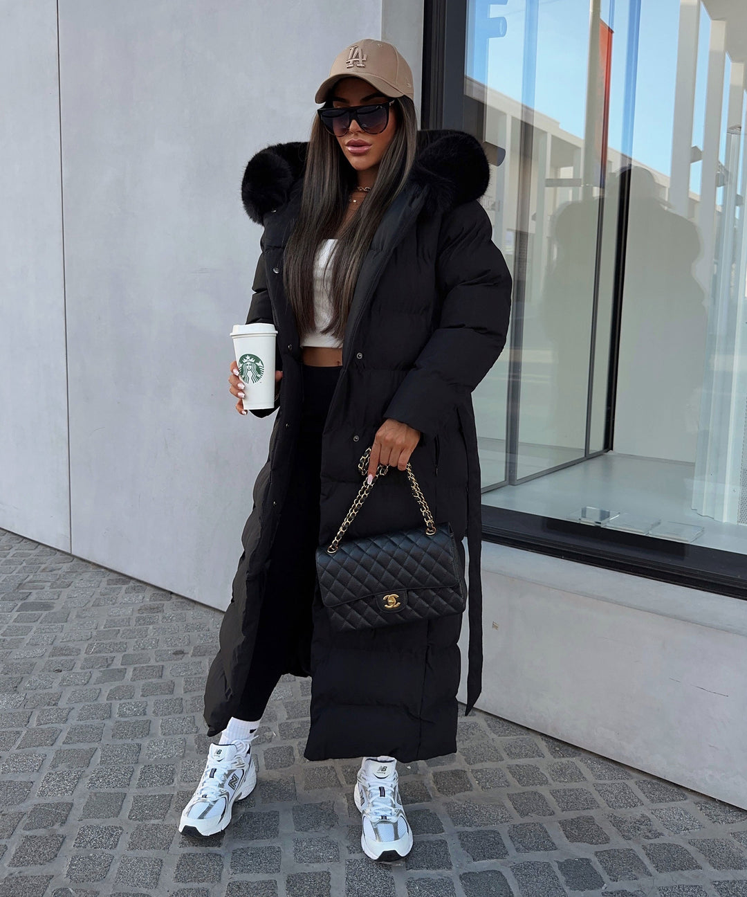 Women's black long quilted puffer coat with fur-look hood