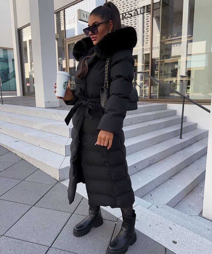Women's black long quilted puffer coat with fur-look hood