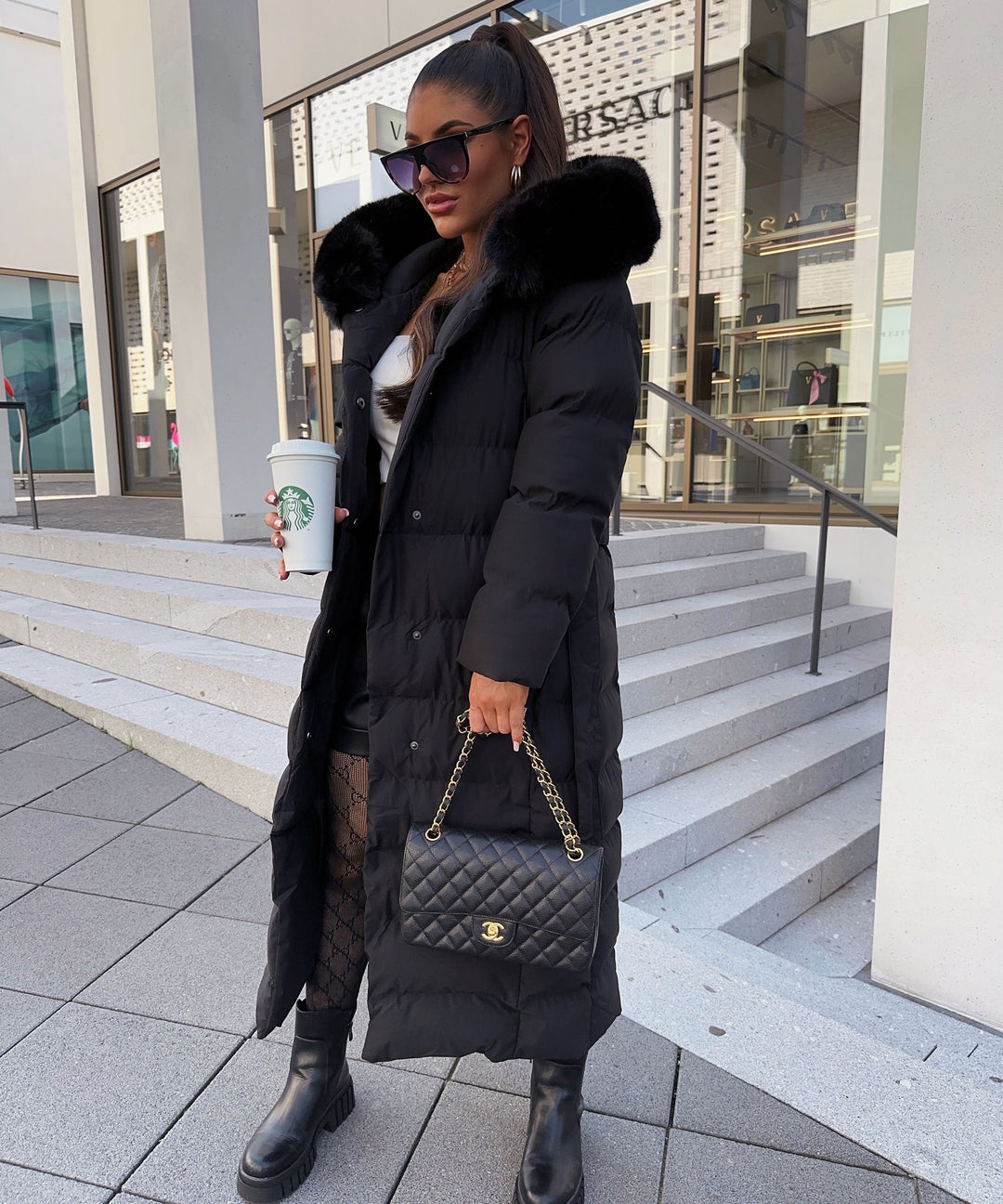 Women's black long quilted puffer coat with fur-look hood