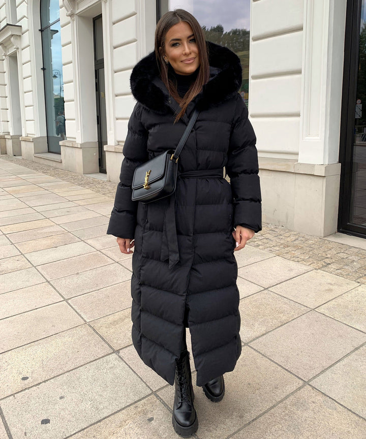 Women's black long quilted puffer coat with fur-look hood