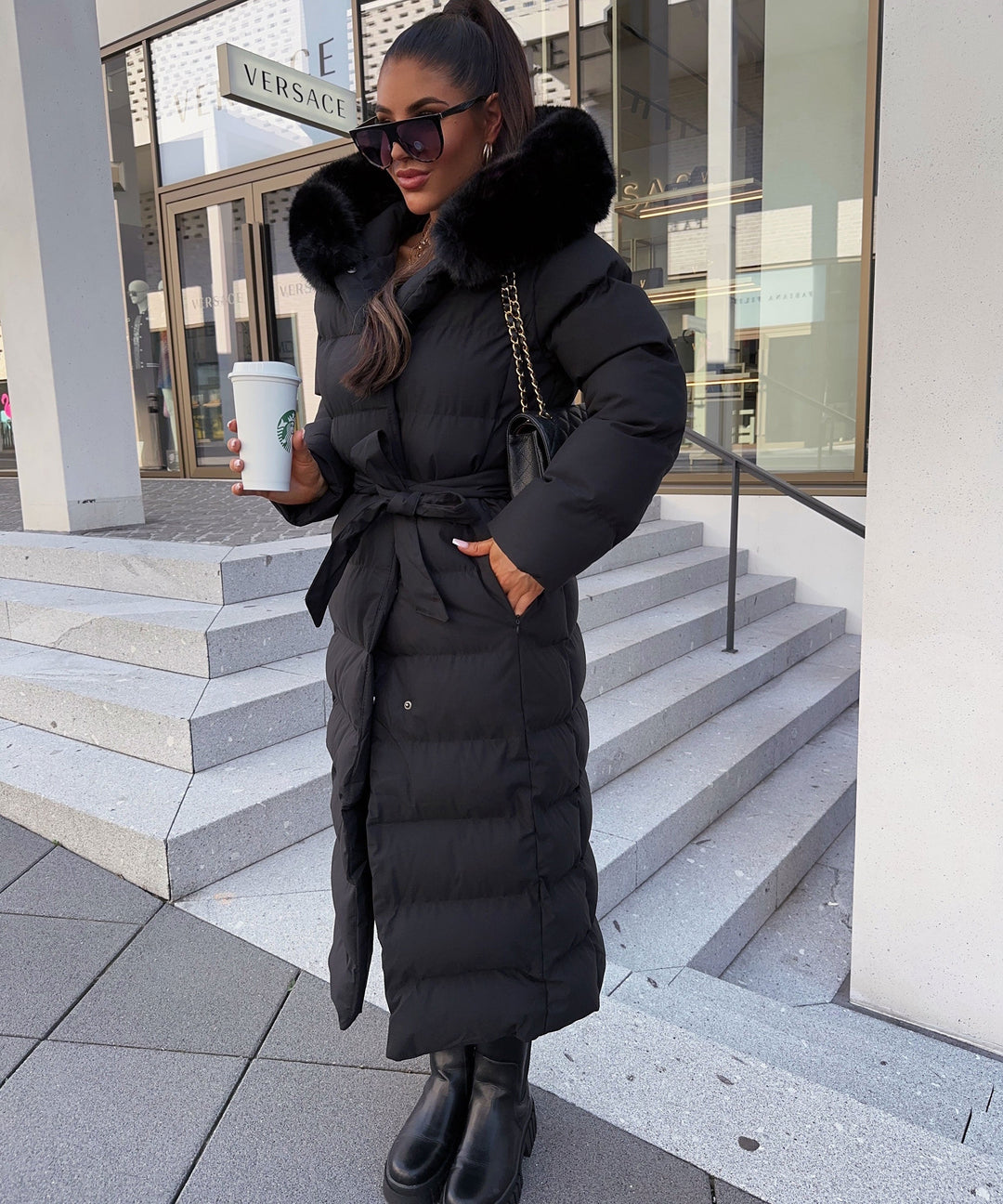 Women's black long quilted puffer coat with fur-look hood