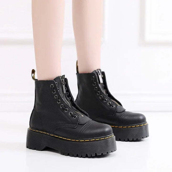 Women's black combat ankle boots with front zipper, laces and chunky platform soles