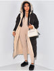 Women's longline reversible hooded quilted jacket shown with fleece-look lining