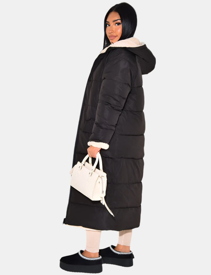 Women's longline reversible hooded quilted jacket shown with fleece-look lining