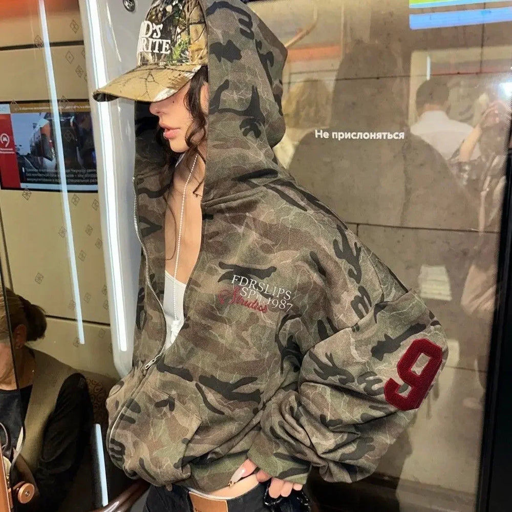 Women's brown camouflage zip hoodie with hood and red sleeve detail