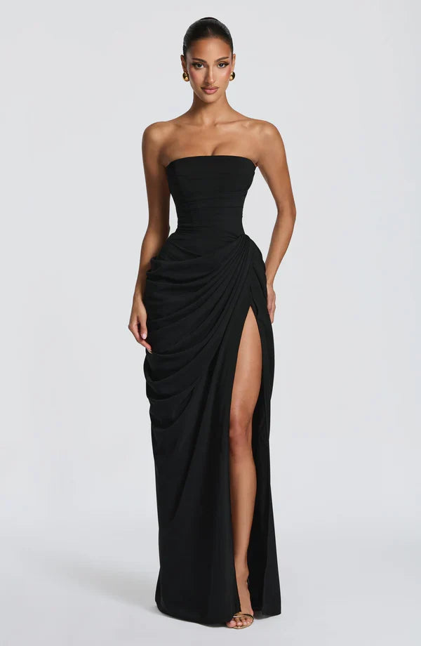 Woman wearing strapless ruched maxi dress with high side slit in yellow and navy versions