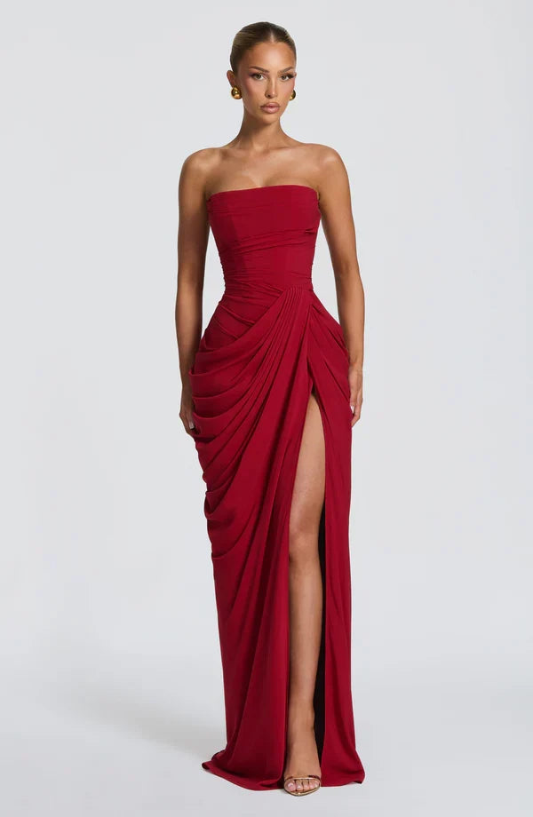 Woman wearing strapless ruched maxi dress with high side slit in yellow and navy versions