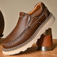 Brown and black moc-toe loafers with contrast stitching and lug soles