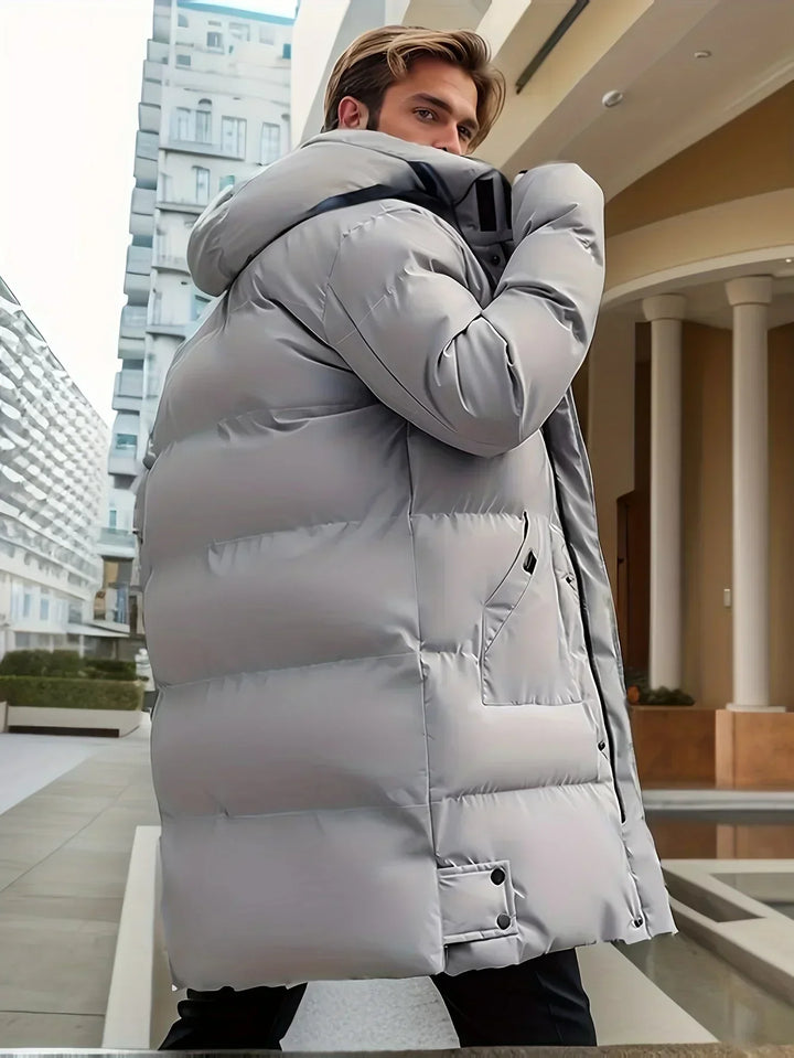 Men's longline hooded puffer coat with quilted panels and front pockets