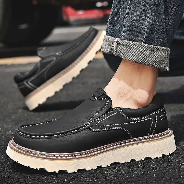 Brown and black moc-toe loafers with contrast stitching and lug soles