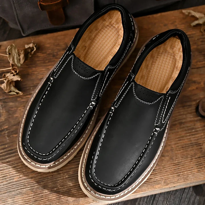 Brown and black moc-toe loafers with contrast stitching and lug soles