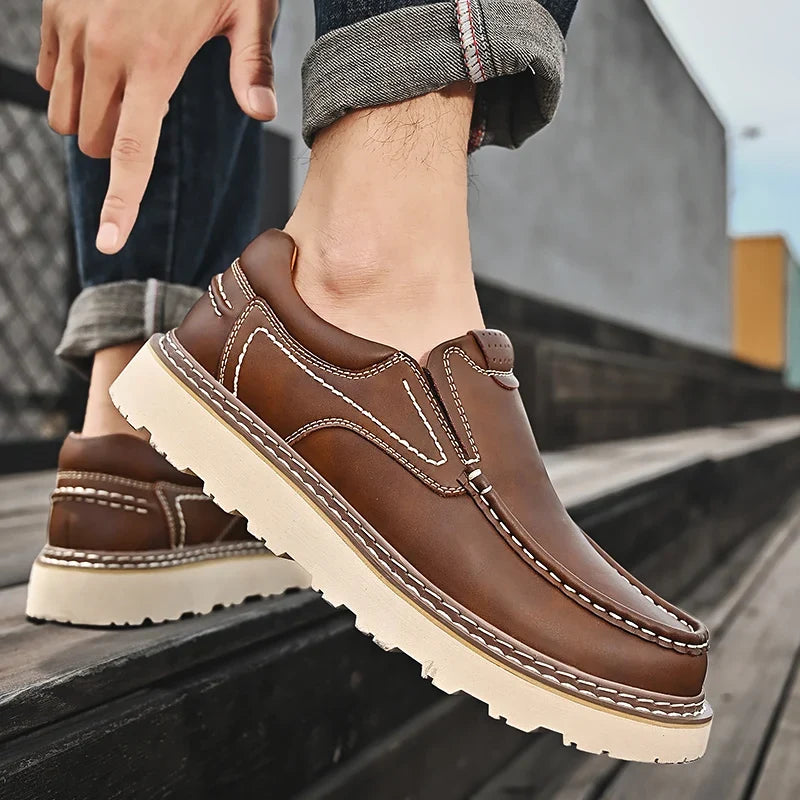 Brown and black moc-toe loafers with contrast stitching and lug soles