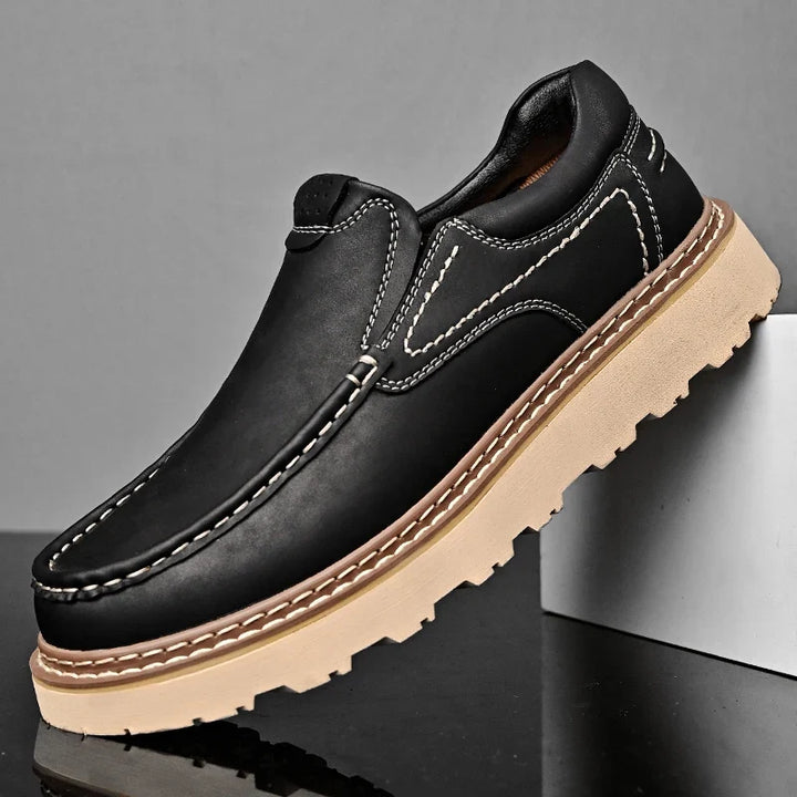 Brown and black moc-toe loafers with contrast stitching and lug soles