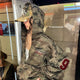 Women's brown camouflage zip hoodie with hood and red sleeve detail