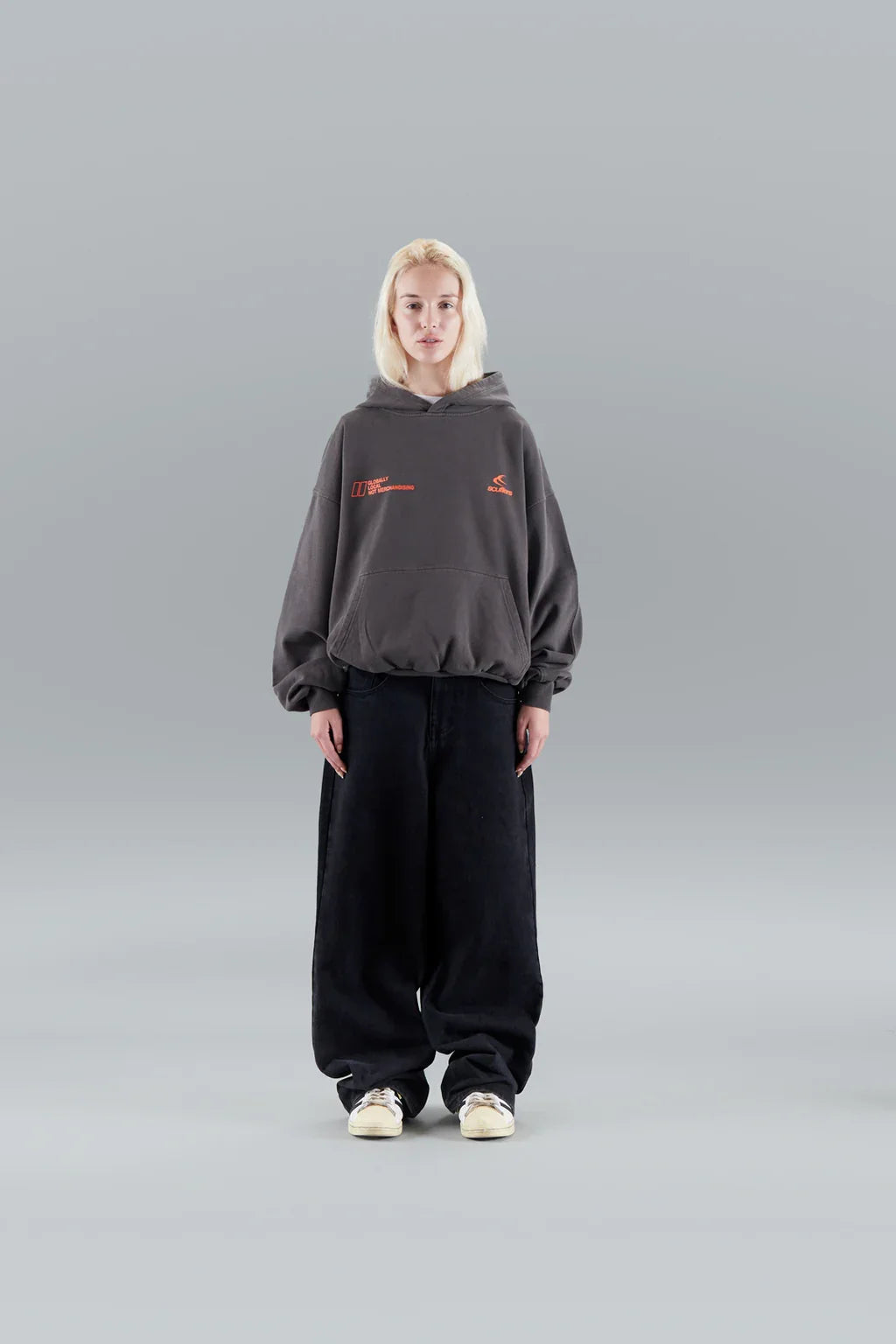 Model wearing an oversized graphic pullover hoodie with hood, long sleeves and kangaroo pocket