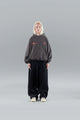 Model wearing an oversized graphic pullover hoodie with hood, long sleeves and kangaroo pocket