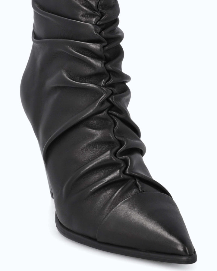 Black ruched ankle boots with pointed toes and high stiletto heels