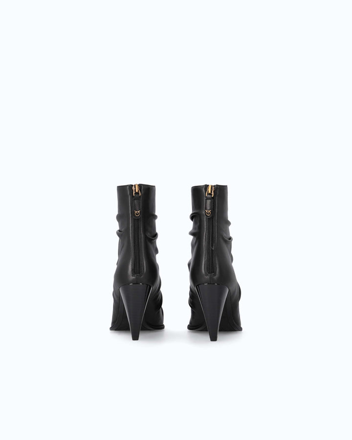 Black ruched ankle boots with pointed toes and high stiletto heels