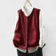 Women's sleeveless button front sweater vest layered over a shirt