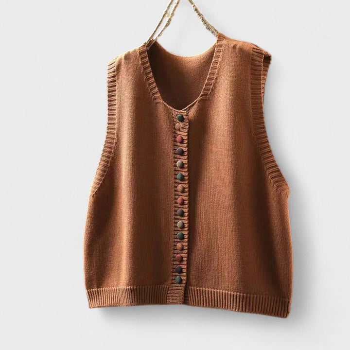 Women's sleeveless button front sweater vest layered over a shirt