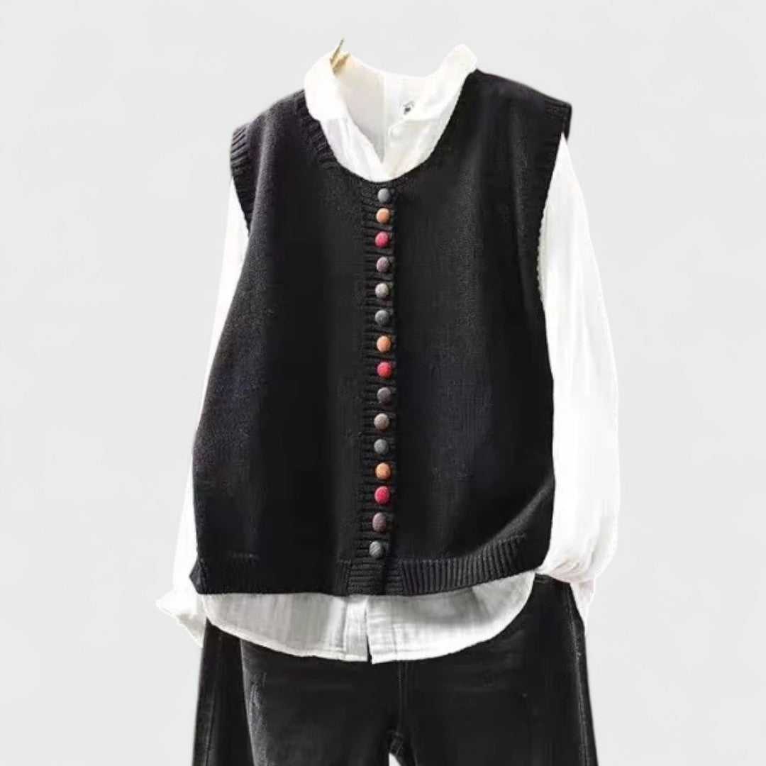 Women's sleeveless button front sweater vest layered over a shirt
