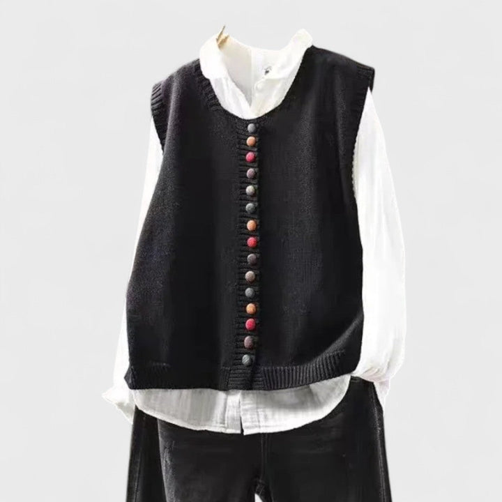 Women's sleeveless button front sweater vest layered over a shirt