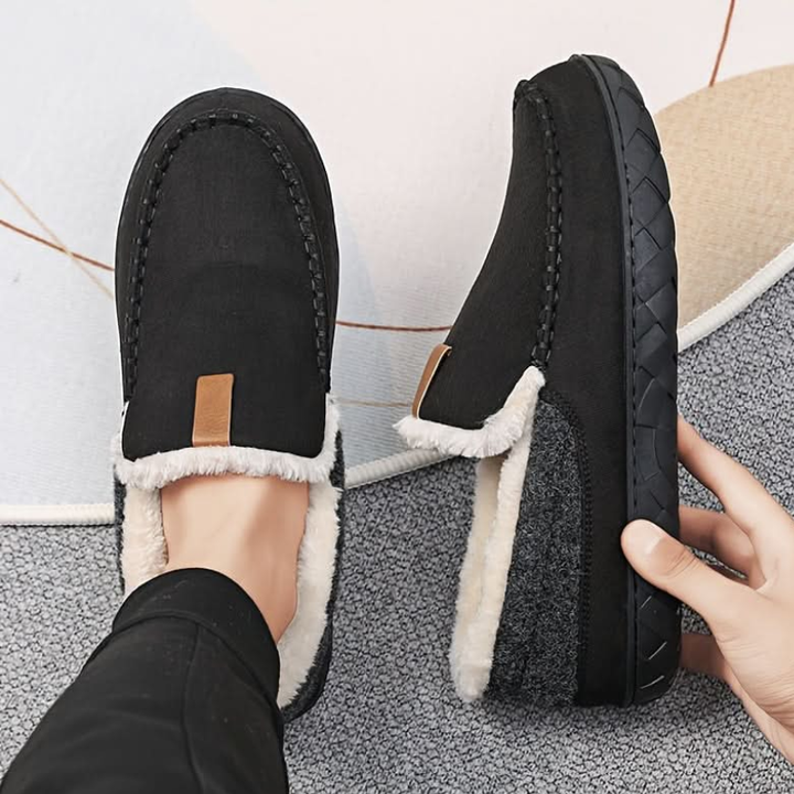 Men's lined slip-on moccasin slippers with plush trim and flat treaded soles