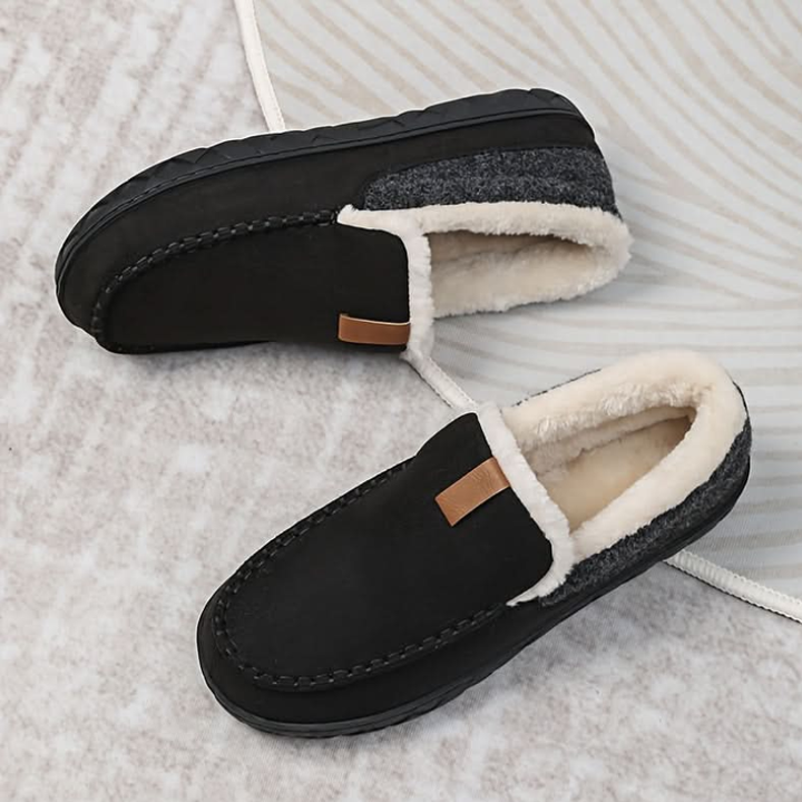 Men's lined slip-on moccasin slippers with plush trim and flat treaded soles