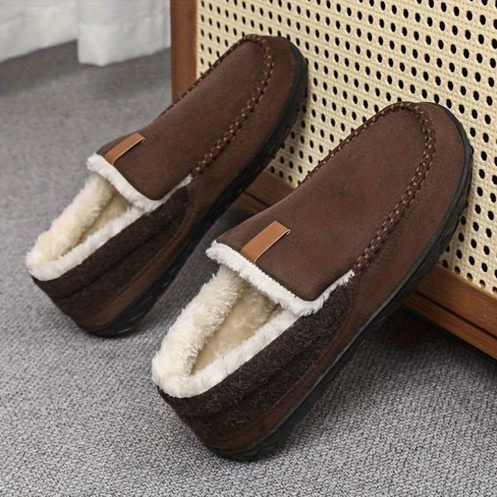 Men's lined slip-on moccasin slippers with plush trim and flat treaded soles