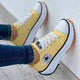 Women's low-top lace-up sneakers with platform soles and side patches