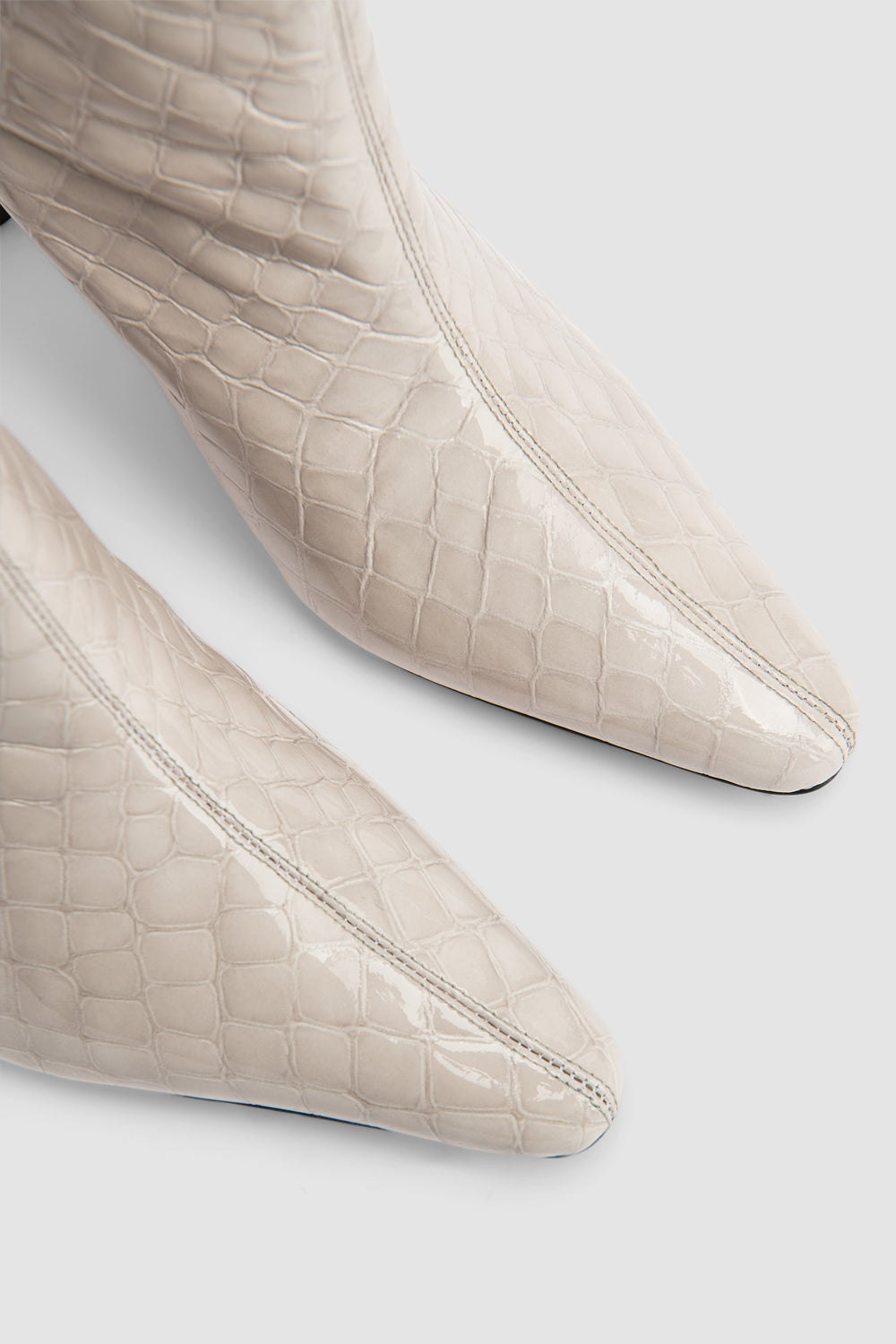 Women's beige croco embossed knee-high boots with pointed toes and stiletto heels